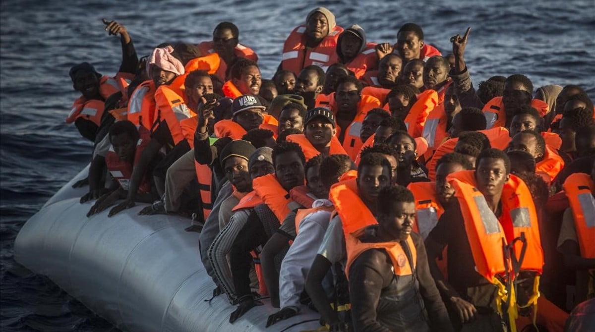 Sub-saharan refugees and migrants on an overcrowded dinghy wait to be rescued by a team of the Spanish NGO Proactiva Open Arms 24 miles north of Sabratha Lybia inside the so called Search and Rescue zone SAR early in the morning on Tuesday July 19 2016 AP Photo Santi Palacios